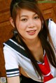 A woman in a sailor outfit posing for a picture.