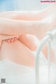 A close up of a woman's legs in a white dress.