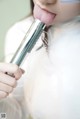 A woman is taking a shower with her tongue out.