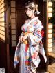 A woman in a kimono standing in front of a door.