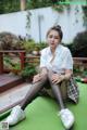 A woman sitting on top of a pool table.